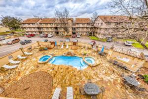 an overhead view of a pool with chairs and a building at Water Wheel Resort Condo Resort in New Braunfels