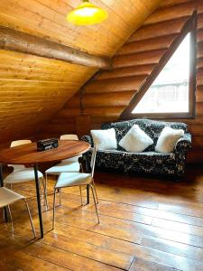 a living room with a couch and a table at Harmonie Tree house Cotagges Chalet Predeal Trei Brazi in Predeal