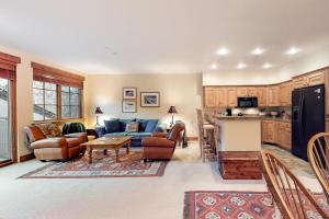 a living room with a couch and a kitchen at Westridge 11 in Ketchum