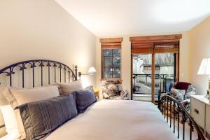 a bedroom with a large bed and two chairs at Westridge 11 in Ketchum