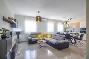 a living room with a couch and a table at Vila Rozarija in Trogir