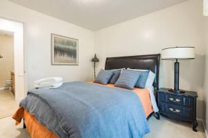 a bedroom with a large bed with a phone on it at Spacious Stay near Airport, Downtown & Ski Resorts in North Salt Lake +8 photos
