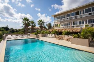an exterior view of a house with a swimming pool at JT Curacao Apartments in Jan Thiel