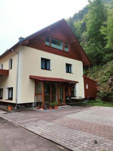 a large white building with a picnic table in front at Seeblick Krippenstein in Obertraun