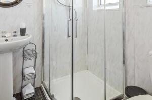 a bathroom with a shower and a sink at Alderberry Lodge in Newquay