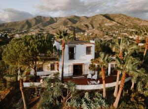 an aerial view of a house with palm trees at The Collector's House Finca with sea view in Mijas