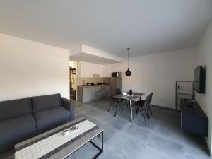 a living room with a couch and a table at Apartmani Nerium in Lovište