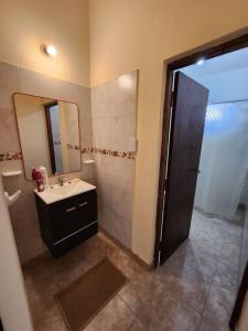 a bathroom with a sink and a mirror at casa Mia Fausti Cafayate, salta in Cafayate