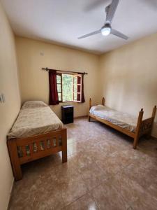 a bedroom with two beds and a window at casa Mia Fausti Cafayate, salta in Cafayate