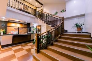 a staircase in a building with potted plants at Madonna Hometel and Suites in Panabo