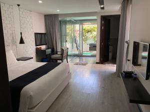 a hotel room with a bed and a living room at M Villa Nha Trang in Nha Trang