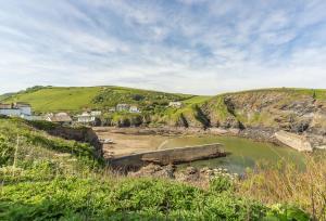 a view of the shoreline of a beach with houses at September Sea in Port Isaac