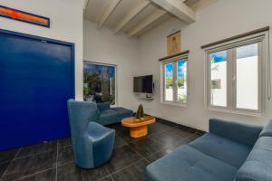 a living room with blue couches and a flat screen tv at A Serene Retreat with Modern Amenities in Santa Cruz