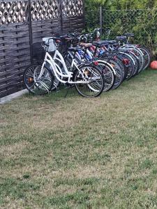 a row of bikes parked next to a fence at Wakacje nad morzem w Rusinowie in Rusinowo