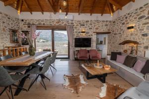 a living room with a stone wall at Lasithi Luxury Villa in Mésa Lasithákion