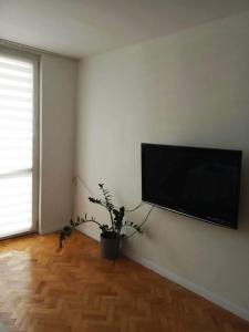 a living room with a flat screen tv on a wall at Apartament Doris in Ciechocinek