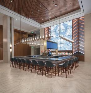 a bar with chairs and a long table in a room at Harrah's Cherokee Casino Resort in Cherokee