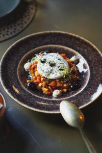a plate of food with an egg on top at Hotel Taburiente S.C.Tenerife in Santa Cruz de Tenerife