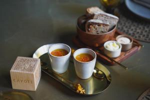 a table with three cups of soup and a plate with bread at Hotel Taburiente S.C.Tenerife in Santa Cruz de Tenerife