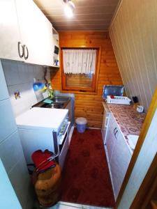 a small kitchen with a sink and a stove at Vikendica Luna in Gornja Šišava