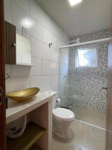 a bathroom with a sink and a toilet and a window at Floripa Beach House Hostel in Florianópolis +71 photos
