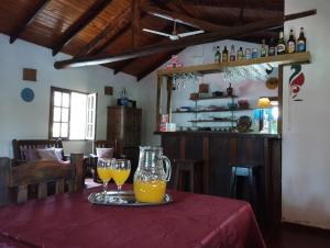 a table with two glasses of orange juice on it at Los Tangueros in Puerto Iguazú