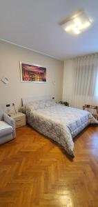 a bedroom with a large bed and a wooden floor at Bed and breakfast Venice Friends in Mestre