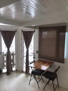 a dining room with a table and chairs and windows at Tiny House Jeri in Jericoacoara +7 photos