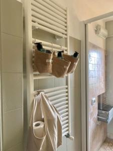 a bathroom with a shower with baskets and a towel at Il Riccio appartamento in Cernobbio