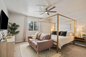 a bedroom with a canopy bed and a couch at Spacious Cool Springs! Central Nampa 3 Bed in Nampa