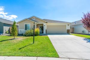 a house with a driveway and a garage at Spacious Cool Springs! Central Nampa 3 Bed in Nampa