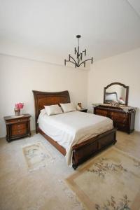 a bedroom with a bed and two tables and a mirror at Vlihadia Bay Luxury Villa in Kalymnos
