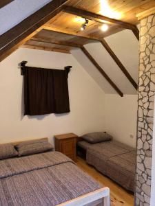 a bedroom with two beds in a attic at Private accommodation Kalezić in Mojkovac