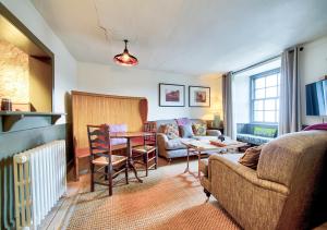 a living room with a couch and a table at The Rock House - Terrace Apartment - in Heart of the City in Edinburgh