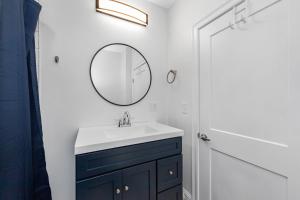 a bathroom with a sink and a mirror at Private Luxury Framingham condo near Boston in Framingham