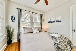 a bedroom with a large white bed and windows at Global Cup The Dreamy Escape on Lower Greenville in Dallas