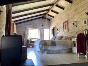a bedroom with a bed in a room with wooden walls at Preciosa y Acogedora Casa, Condominio Privado in Pucón
