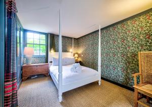 a bedroom with a four poster bed with two pillows at Rock House - Photographer's Studio - Historic Gem in the heart of the City in Edinburgh