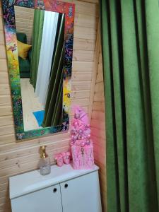 a bathroom with a vanity with a mirror and a sink at Wooden House Nica in Mestia