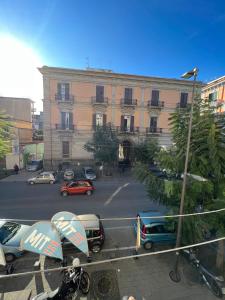 a large building with cars parked in a parking lot at Bell'e Buono vicino aeroporto di Capodichino in Naples