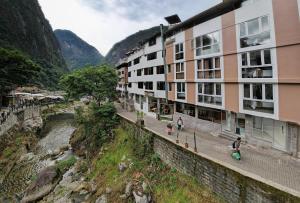 a view of a building next to a river at MAPILAND- Hotel Boutique in Machu Picchu