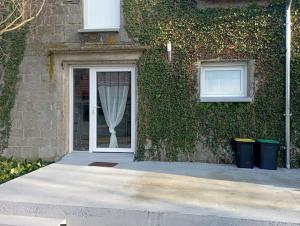 a door to a building with a curtain on it at Loue gîte de campagne 