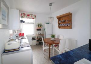 a kitchen with a table and a dining room at Regent Apartment 1 in Blackpool