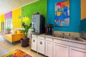 a kitchen with a sink and a microwave at Inn at Palm Springs in Palm Springs