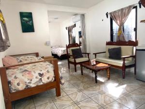 a living room with chairs and a couch at Posada Xtakay Bacalar ''Turix'' in Bacalar