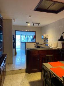 a kitchen with a table and a counter top at Casa Alba in Mindelo