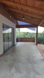 an empty patio with a wooden ceiling and glass doors at Céu da Canastra in Delfinópolis
