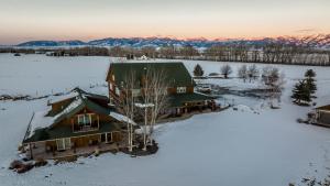 an aerial view of a house in the snow at Gallatin River Lodge in Bozeman