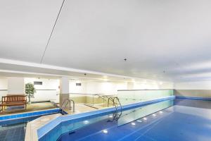 a large swimming pool in a building at QV Stays Upscale Modern Getaway in Auckland