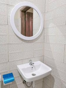 a bathroom with a sink and a mirror at Lima's Vacation 1BR Apt with Wi-Fi & Netflix in Kampala, Namugongo road in Kampala